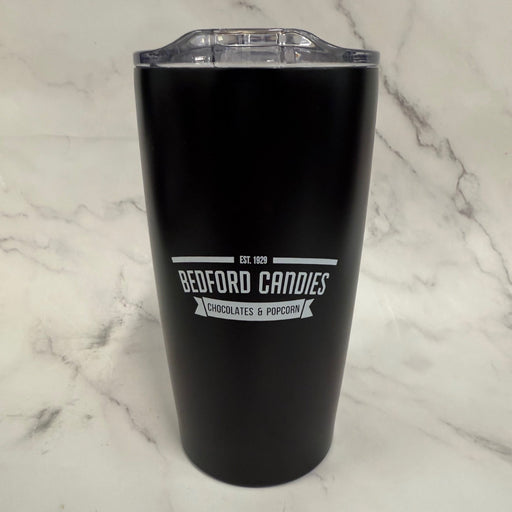 Black tumbler with 'Bedford Candies' branding on a marble surface