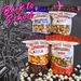 Four bags of Bedford Candies Popcorn with 'Back to School' text on a black background with school supplies.