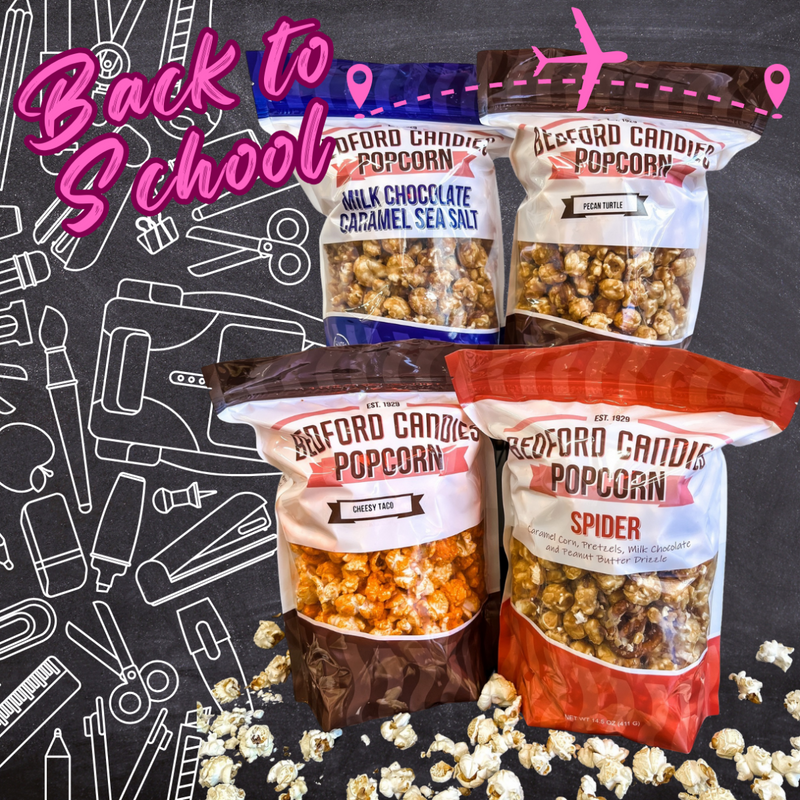 Four bags of Bedford Candies Popcorn with 'Back to School' text on a black background with school supplies.