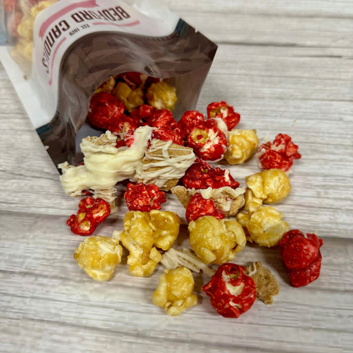 Colorful popcorn spilling out of a bag on a wooden surface